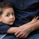 Young boy hugging his dad