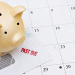 piggy bank sitting on a calendar