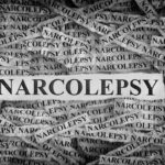 Torn pieces of paper with the words Narcolepsy