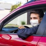 Young driver with face mask